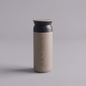KINTO travel tumbler in sand beige, featuring the vertical white text 'grace farms' on the front, set against a solid gray background.