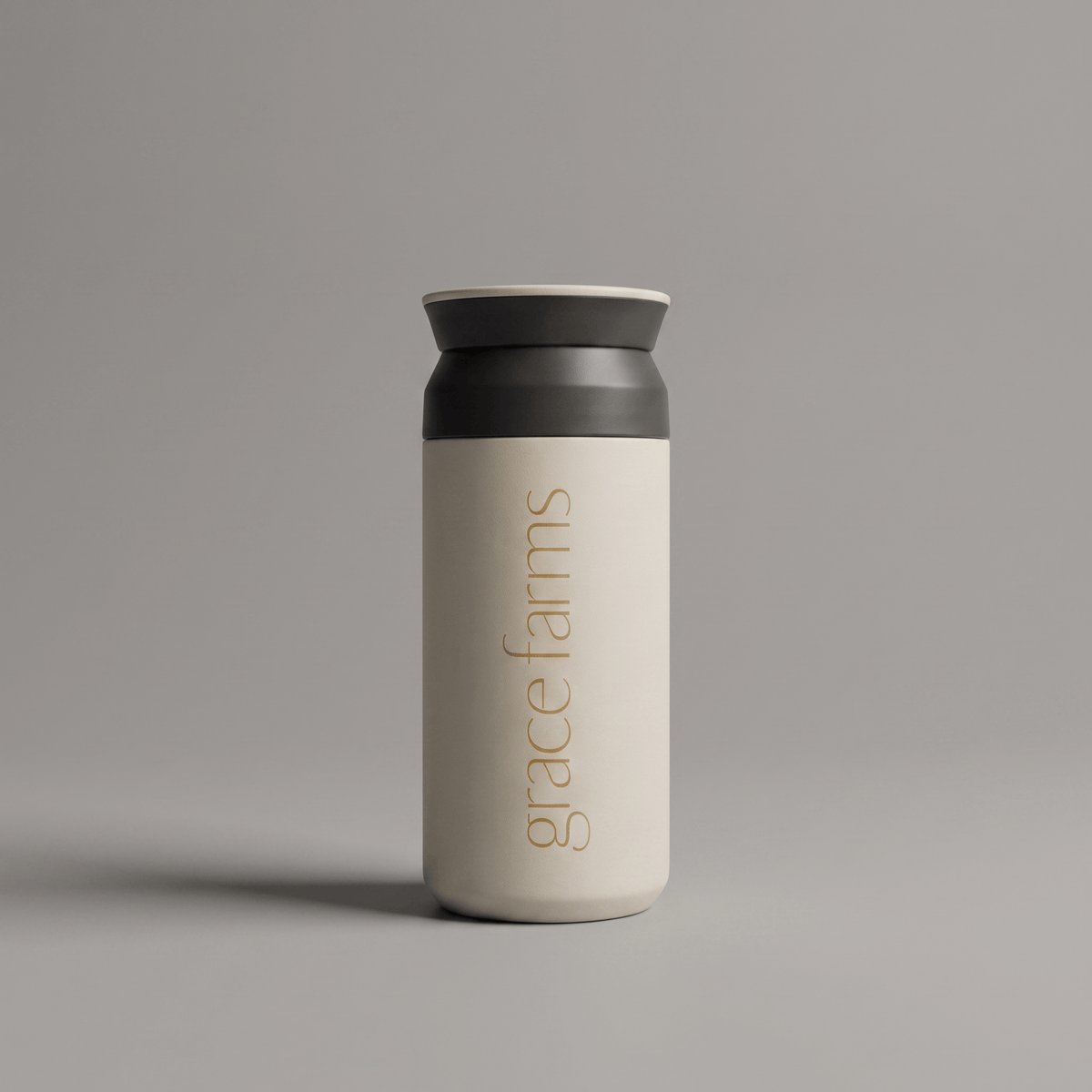KINTO travel tumbler in white, featuring the vertical white text 'grace farms' on the front, set against a solid gray background.